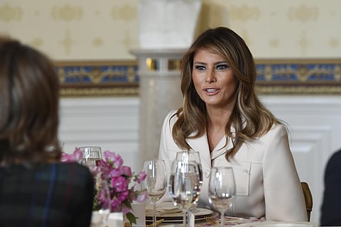 First lady Melania Trump sits down at her table after speaking during the Governors' Spouses' luncheon in the Blue Room of the White House. (Photo| AP)