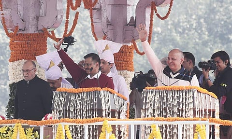 Delhi CM Arvind Kejriwal (L) and minister Manish Sisodia during an oath-taking ceremony at Ramlila Ground in New Delhi on Sunday. (Photo| Parveen Negi, EPS)