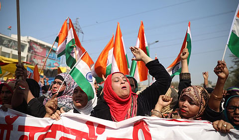 Women wave tricolours during their ongoing protest against CAA and NRC at Shaheen Bagh in New Delhi Sunday Feb. 16 2020. (Photo | EPS)