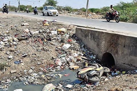 A rented Bounce scooter thrown near a drain near Jagathgiri Gutta, Kukatpally, in Hyderabad on Saturday. (Photo | S Senbagapandiyan, EPS)