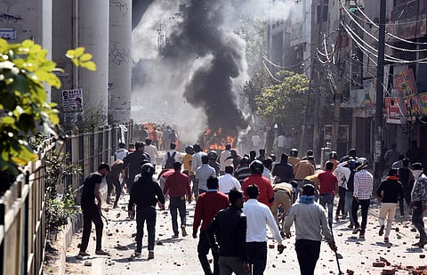 Protesters during clashes between a group of anti and pro CAA supporters at Jafrabad in north-east Delhi on Monday. (Photo | Parveen Negi, EPS)