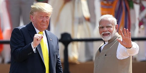 PM Narendra Modi, right, waves as US President Donald Trump reacts to the crowd during the 'Namaste Trump' event at Sardar Patel Stadium in Ahmedabad. (Photo | AP)