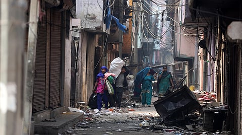 Muslims leave a riot-affected area at Khajuri Khas area in New Delhi on Wednesday. (Photo | Shekhar Yadav/EPS)