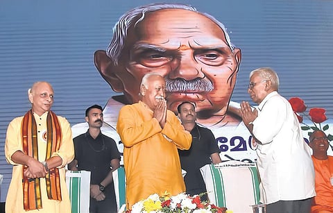 Scholar V R Prabodhachandran Nair greets RSS chief Mohan Bhagwat at ‘Namami Parameswaram’, held in memory of RSS ideologue P Parameswaran, in Thiruvananthapuram on Wednesday. Spiritual leader Sri M is also seen I B P Deepu
