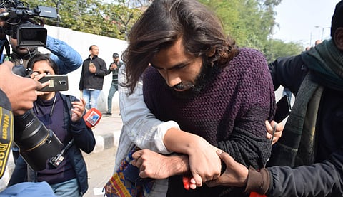 Shadab Farooq, student of the Jamia Millia Islamia university injured after a minor allegedly opened firing during an anti-CAA protest is assisted towards a hospital in New Delhi Thursday Jan. 30 2020. (Photo | EPS)