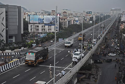 Heavy vehicles and cars ply the recently-completed Benz Circle flyover in Vijayawada on Monday (Photo | Prasant Madugula, EPS)