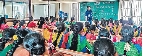Ramasubramaniam teaching the Tamizhi script to the students and teachers at a special workshop;