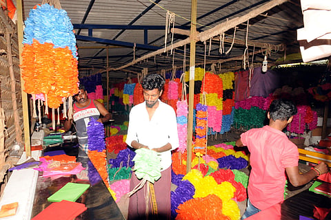 Hundreds of people are involved in the garland-making process in the town near Kulamangalam.