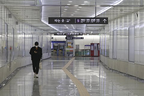 A man wearing a face mask walks alone at a subway station in Seoul, South Korea, Sunday, March 1, 2020. (Photo | AP)