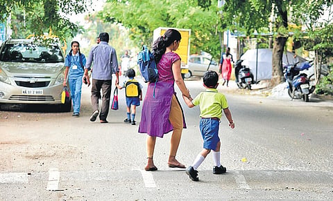 LKG and UKG children return home in Bengaluru on Monday after the state government declared holiday as a precautionary measure against the new coronavirus. (Photo | Vinod Kumar T/EPS)