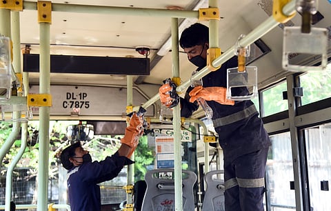 DTC employee disinfecting bus after the directions from government to prevent Coronavirus spread in New Delhi on Monday. (Photo | Parveen Negi)