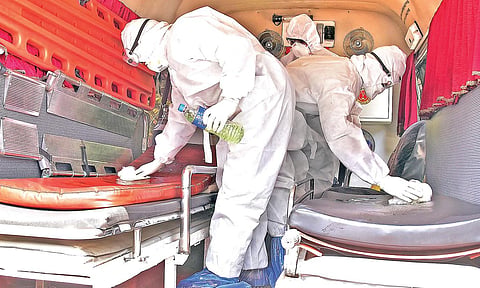The ambulance that ferried two patients who tested positive for COVID-19 infection from Pathanamthitta General Hospital to Kottayam Medical College Hospital, being sanitised by nurses and the driver after its return on Monday | Shaji Vettipuram