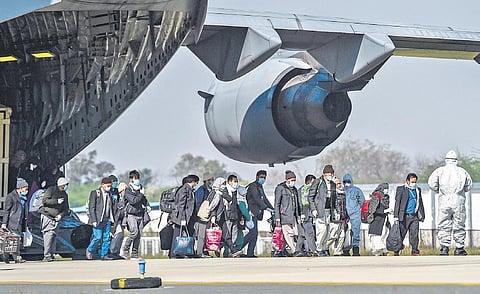Indians disembark at Hindon airbase after they were evacuated to India on an IAF aircraft on Tuesday | PTI