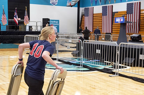 A worker carries chairs after a campaign rally for Democratic presidential candidate former Vice President Joe Biden was cancelled at Cuyahoga Community College Tuesday, March 10, 2020, in Cleveland, due to health concerns with the coronavirus. (Photo | A