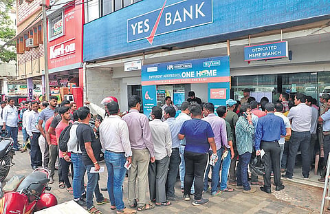 Customers queue up outside Yes Bank to withdraw cash in Bhubaneswar (Photo | Irfana)