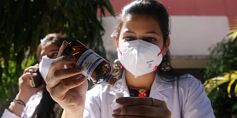 A doctor pours medicine to be used as a precaution against COVID-19, at Nehru Homeopathic Medical College. (Photo| Shekhar Yadav, EPS)