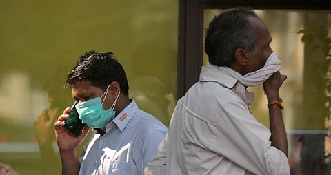 A man wearing a protective mask in the wake of novel coronavirus or COVID-19 outbreak speaks on the phone. (Photo | Shekhar Yadav/EPS)