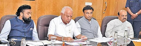 Chief Minister B S Yediyurappa speaks with PM Narendra Modi during a video conference on tackling COVID-19. Health Minister B Sriramulu, Medical Education Minister Dr Sudhakar and officers were present | express
