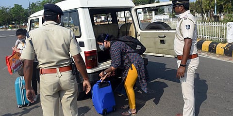 Security personnel helping passengers for a drop at Airport during Janata Curfew in Bhubaneswar on Sunday. (Photo| Biswanath Swain, EPS)