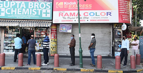 People stand in a queue outside a chemist shop while maintaining social distancing during a nationwide lockdown in the wake of coronavirus pandemic in New Delhi. (Photo | Parveen Negi, EPS)