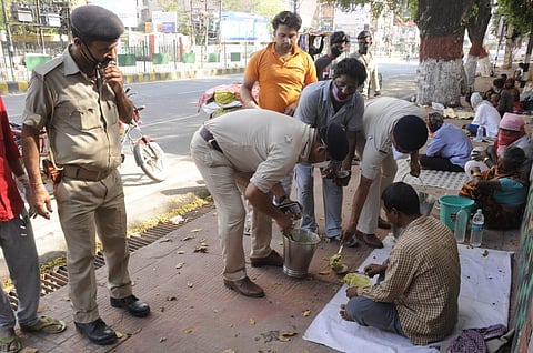Cops feeding the needy (Photo | Ranjit K Dey)