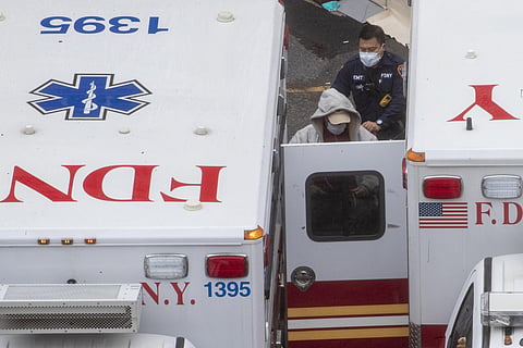 A paramedic transports a patient into the Trauma Center at the Elmhurst Hospital Center, Sunday, March 29, 2020, in the Queens borough of New York. (Photo | AP)