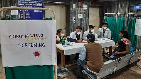 Doctors screen a patient in an area set aside for possible COVID-19 patients at a homeopathic hospital in New Delhi. (Photo | Shekhar Yadav, EPS)