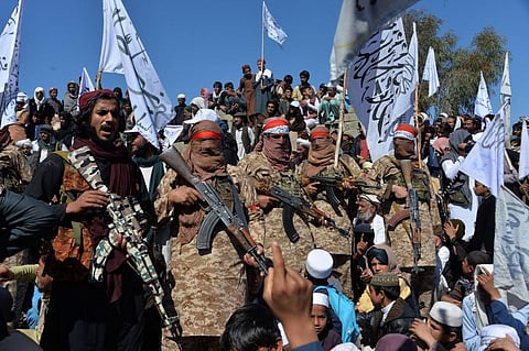 Taliban militants and villagers celebrate the peace deal and their victory in the Afghan conflict in Laghman province on Tuesday (Photo | AFP)