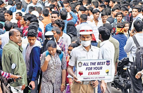 File | A policeman at SR Nagar in Hyderabad wishes students best of luck on the first day of the Intermediate Public Examinations