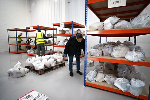 Volunteers help pick items for food packages to help those confined to their homes during the lockdown in London. (Photo | AP)