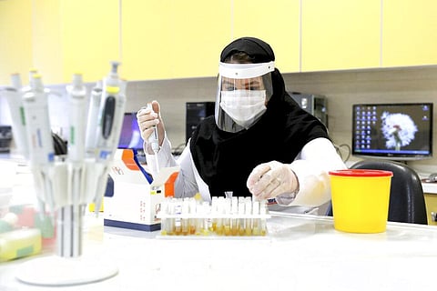 A scientist works in a lab on coronavirus testing kits just outside Tehran, Iran. (Photo | AP)
