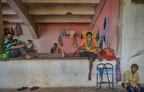 Migrant workers and homeless people rest at a temporary camp set up on the premises of a stadium during ongoing COVID-19 lockdown in Thane Wednesday. (Photo | PTI)