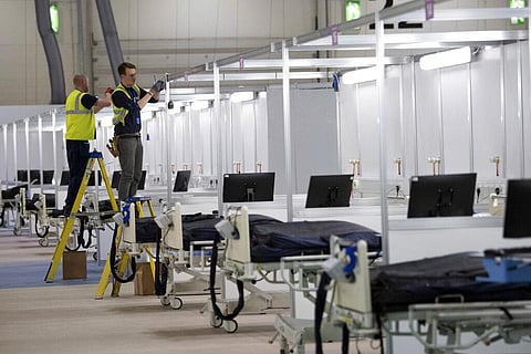 In the fight against the coronavirus pandemic, soldiers are delivering millions of face masks to hospitals and helping to build makeshift medical facilities, including one at London's ExCel convention center that can treat as many as 4,000 patients. (Phot