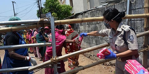 Free sanitary napkins being distributed by Commisionrate Police at containment zone of Surya Nagar in Bhubaneswar. (Photo | Biswanath Swain, EPS)