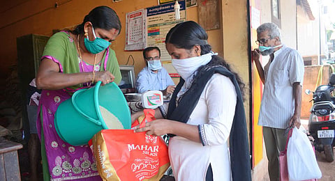 People standing in the ration shop to get their free ration. (Photo | Manu R Mavelil, EPS)