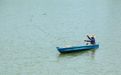 A man fishing in Korappuzha river at Kuniyilkadavu bridge in Kozhikode. (Photo | T P Sooraj, EPS)