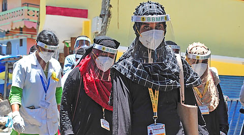 BBMP health workers go around Padarayanapura in Bengaluru on Monday, a day after the area witnessed violence | Pandarinath B