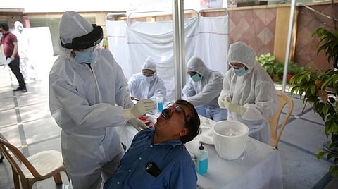 A doctor takes a swab sample of a journalist at a COVID-19 coronavirus testing camp for journalists in New Delhi on Wednesday. (Photo | Shekhar Yadav, EPS)