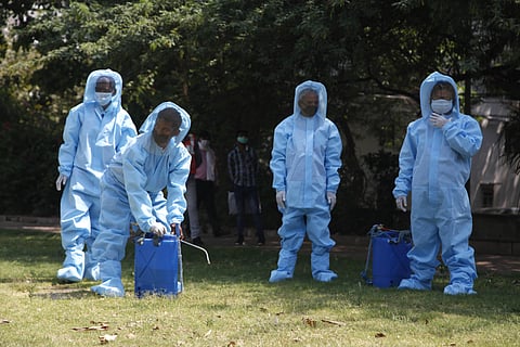 Sanitaion workers wear PPE kit during a PPE kit dsitribution programme in Defense colony during the nationwide lockdown in New Delhi on Tuesday. (Photo | Anil Shakya/EPS)