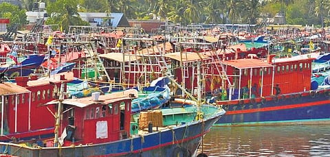 workers idling in boats anchored at Kalamukku Harbour. The lockdown has left the sector in shambles ,Albin Mathew