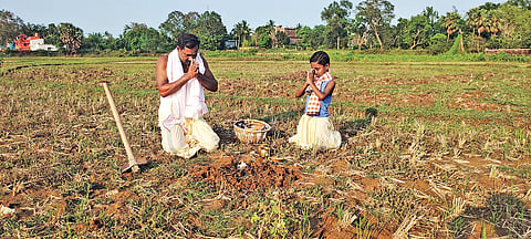 A father-son duo worshipping Mother Earth on Akshaya Tritiya in a village | Akshya Rout