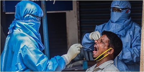 A health worker collecting swab sample at ID market in Bhubaneswar. (Photo | Biswanath Swain, EPS)
