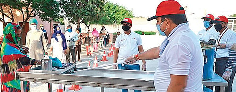Volunteers at Chandigarh University with a a special serving trolley. (Photo| EPS)