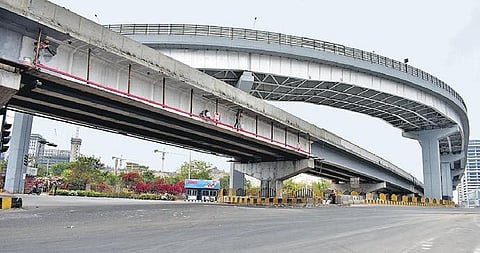 Workers painting the flyover which is under construction at Biodiversity junction near Gachibowli on Saturday | S Senbagapandiyan