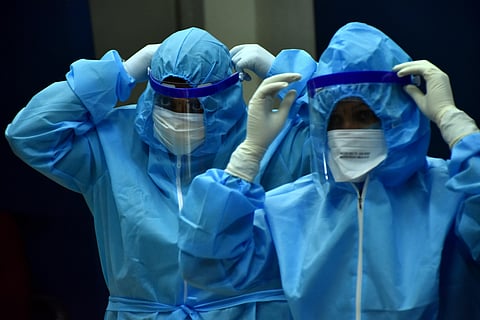 Healthcare workers getting ready by donning PPE with face shields before testing swabs through RT-PCR method. (Photo | Rakesh Kumar, EPS)