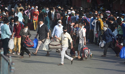Migrants gather outside Dharavi slums to take buses to reach a railway station and board a special train to their native places during the ongoing COVID-19 nationwide lockdown in Mumbai Friday May 15 2020. (Photo | PTI)