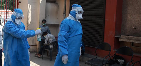 Health workers wear protective gear sanitize their body during the nation wide lockdown in New Delhi on Saturday. (Photo | Shekhar Yadav/EPS)