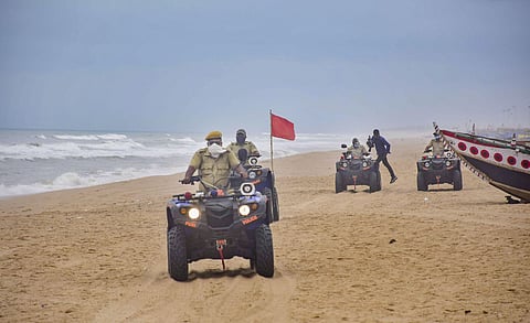 Marine police personnel patrol Puri beach to prevent tourists and fishermen from venturing into the sea due to Cyclone Amphan in Puri. (Photo | PTI)