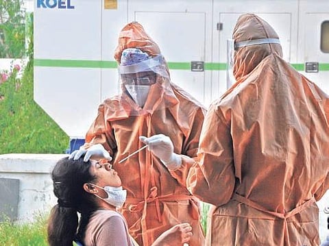 Swab samples being collected from a foreign returnee in Vijayawada on Sunday I Prasant Madugula