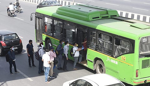 Office workers board DTC busses at Akshardham as the Delhi Government resumed bus services within the city.on Tuesday Express photo by Parveen Negi